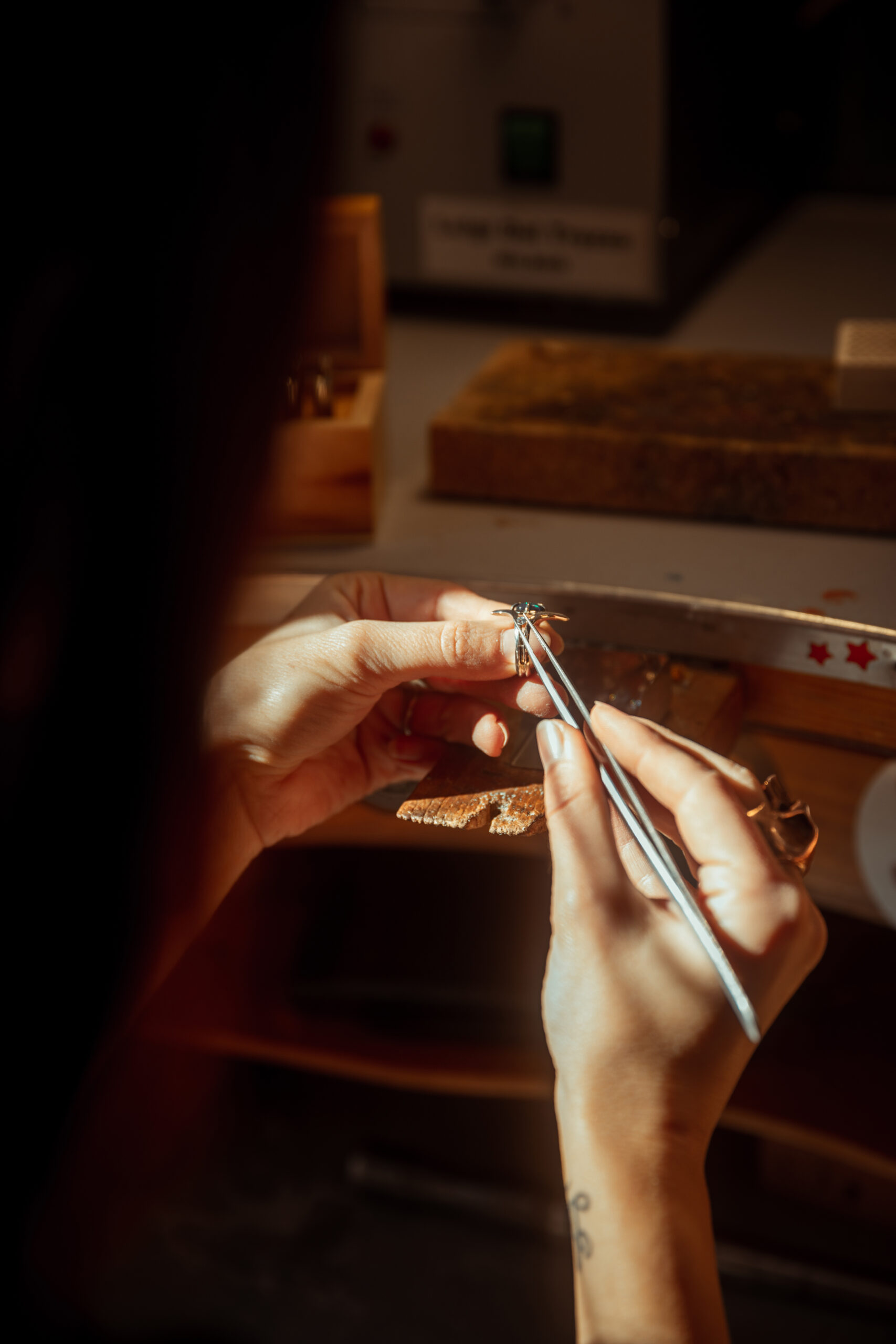 Woman jeweller working on a gemstone